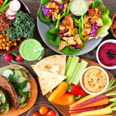 Kolorowe warzywa, hummus, smoothie i pieczywo – to wszystko pokazuje, co to jest weganizm: pyszne i zdrowe jedzenie bez produktów odzwierzęcych.