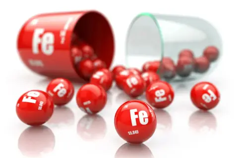 Czerwone kapsułki i kulki z symbolem "Fe" oznaczają suplementację żelaza.